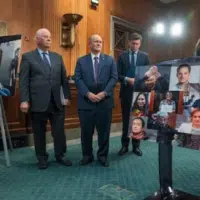 From left, Senator Ben Cardin (D-MD), Senator Chris Coons (D-DE), and James Roscoe, deputy head of mission at the British Embassy in Washington, D.C., listen as Evgenia Kara-Murza, rights advocate and wife of Vladimir Kara-Murza, speaks about her husband at an NED-sponsored event on Capitol Hill on April 9. [Source: thenationalnews.com]